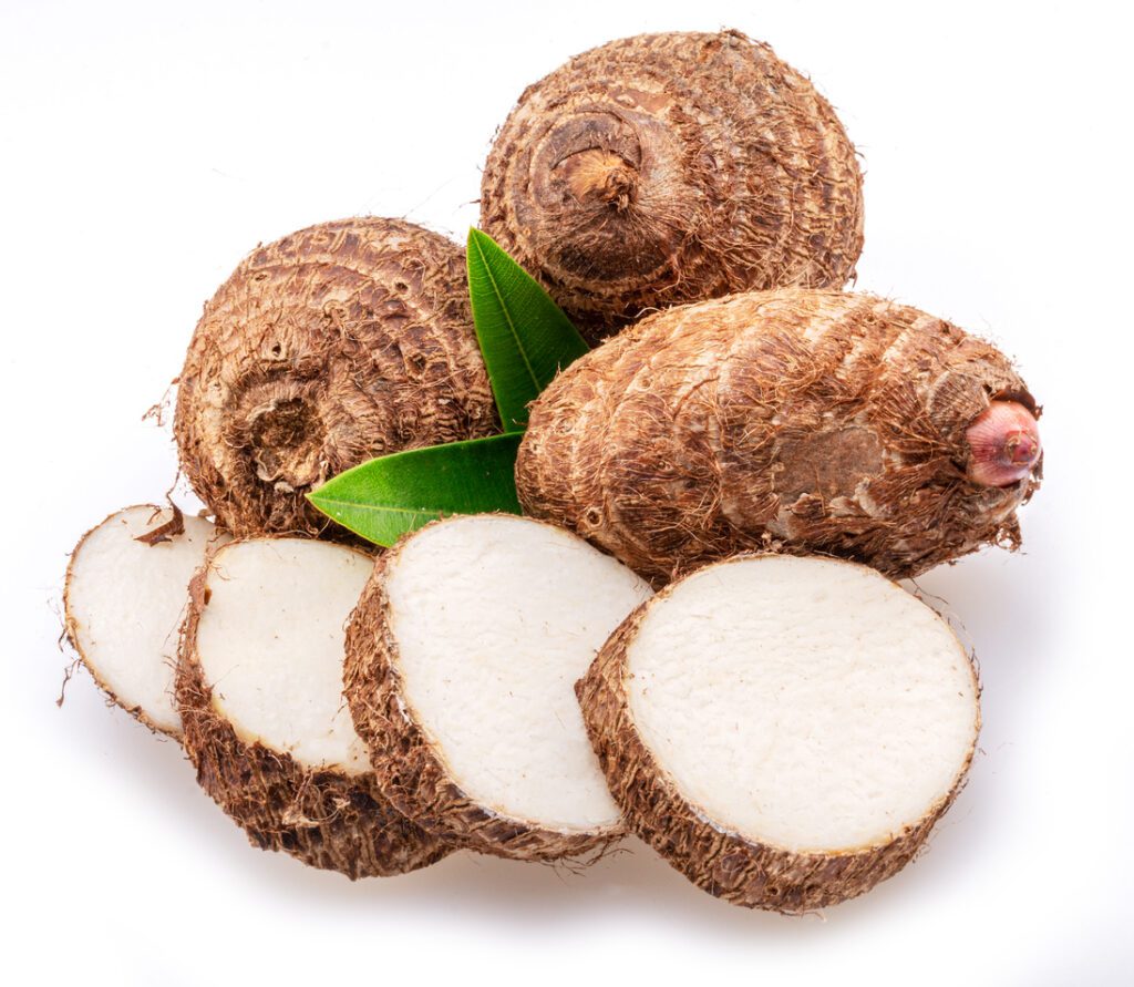 eddoe or taro tubers and its slices isolated on white background.